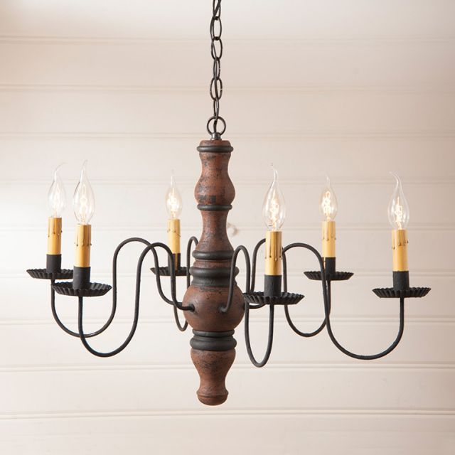 Primitive wood chandelier with 6 tin cups and metal arms lit with bulbs and hanging from black chain