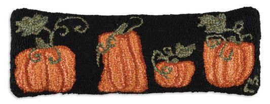 Primitive hooked pillow with four orange pumpkins