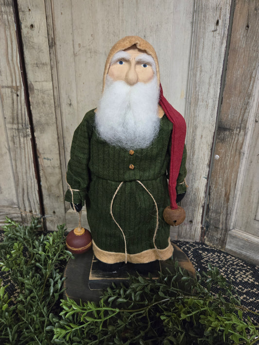 Primitive Small Santa with Green Coat Holding Wooden Ornament