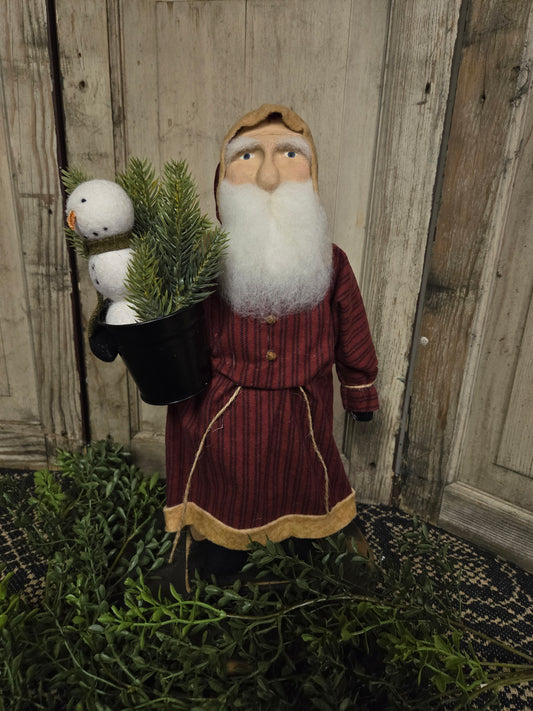 Primitive Small Santa with Red Coat Holding Snowman and Greenery