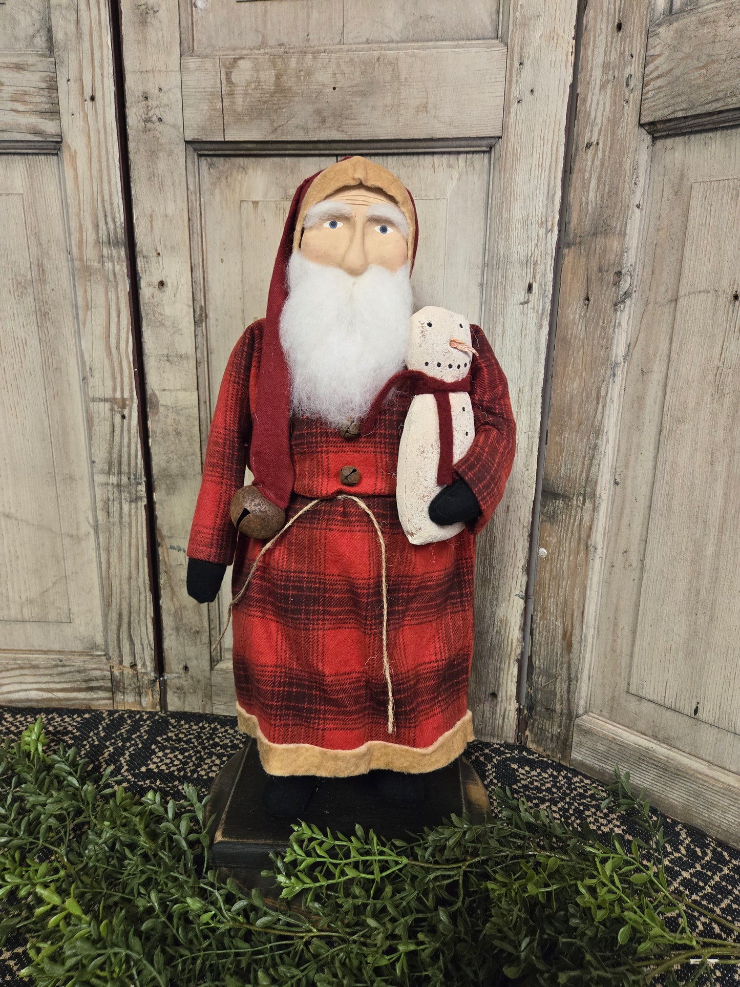 Medium Primitive Santa with Red Plaid Coat Holding Snowman