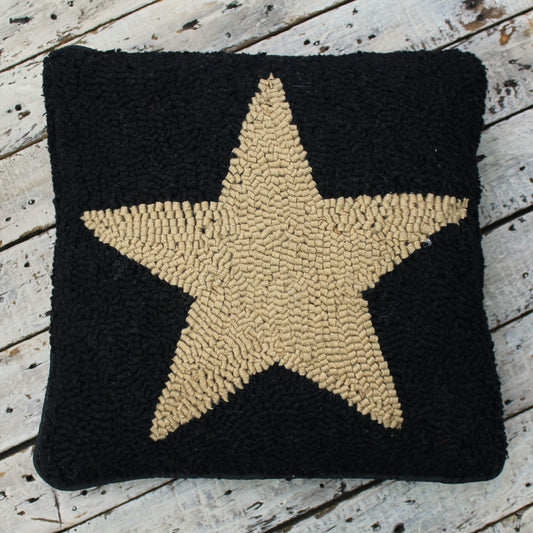 Primitive hooked pillow with cream colored star on black 