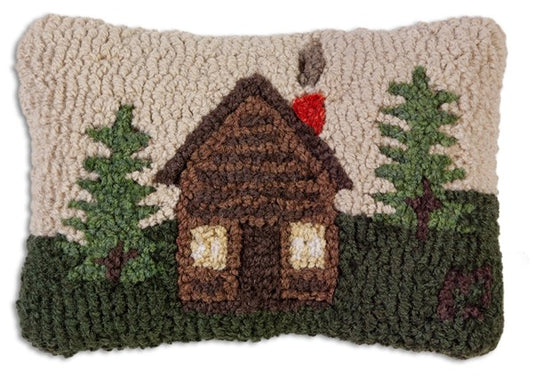 Primitive hooked pillow with cabin and trees